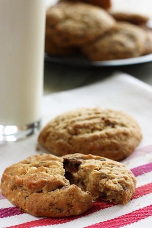 Homemade chocolate and nut cookies with a glass of milkの写真素材