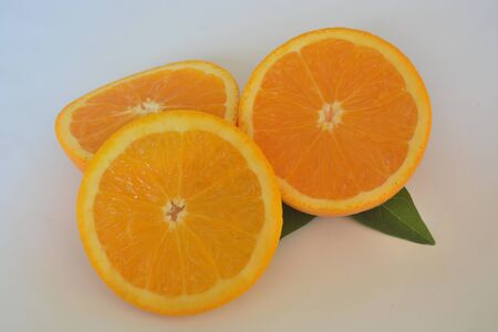 Sliced orange fruit on white backgroundの写真素材