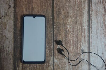 Blank screen smartphone on wood tableの写真素材