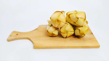 Kupat or ketupat Indonesian traditional food with rice ingredients wrapped with palm leaves isolated on white backgroundの写真素材