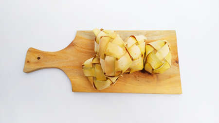 Kupat or ketupat Indonesian traditional food with rice ingredients wrapped with palm leaves isolated on white backgroundの写真素材