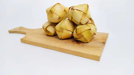 Kupat or ketupat Indonesian traditional food with rice ingredients wrapped with palm leaves isolated on white backgroundの写真素材