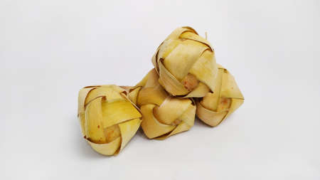 Kupat or ketupat Indonesian traditional food with rice ingredients wrapped with palm leaves isolated on white backgroundの写真素材