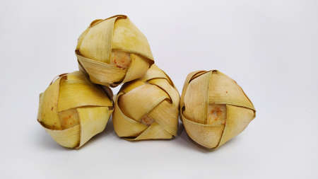 Kupat or ketupat Indonesian traditional food with rice ingredients wrapped with palm leaves isolated on white backgroundの写真素材