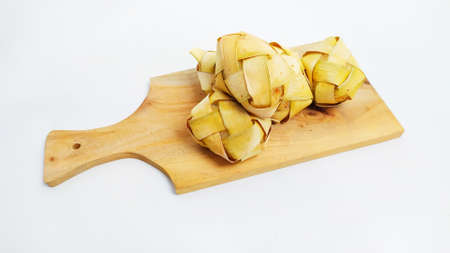 Kupat or ketupat Indonesian traditional food with rice ingredients wrapped with palm leaves isolated on white backgroundの写真素材