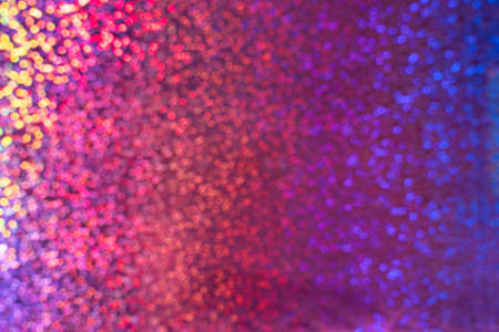 A rainbow sparkle background with colourful bokeh. Multi-colored disco backgroundの写真素材