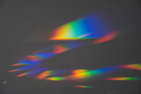 Prism Rainbow Specs on Grey Background Overlayの写真素材