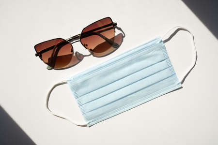 Dark Sunglasses and a blue face maskの写真素材