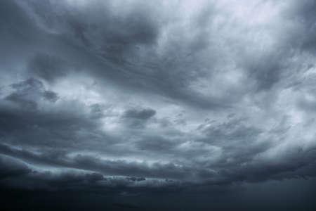 A dramatic storm nimbostratus cloud grey sky backgroundの写真素材