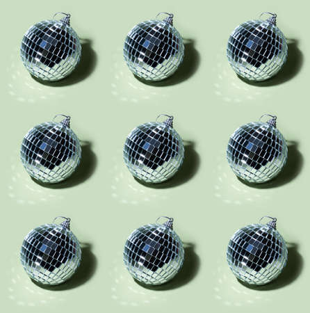 silver mirror Disco ball pattern on basil green background Harsh shadow. Aesthetic minimal hipster...