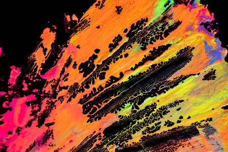 Abstract vibrant multi-color wet paint drops and splotch on black background. Bright orange and pink neon colors. Street art isolatedの写真素材