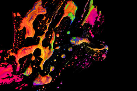 Abstract vibrant multi-color wet paint drops and splotch on black background. Bright orange and pink...