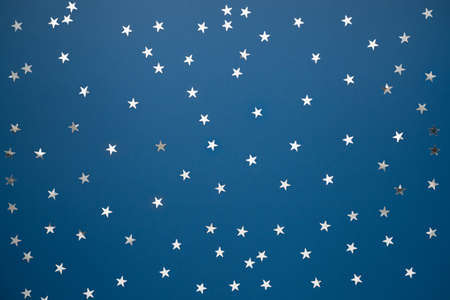 blue background with silver stars confetti. Night sky minimalism concept. Clean background for web bannerの写真素材