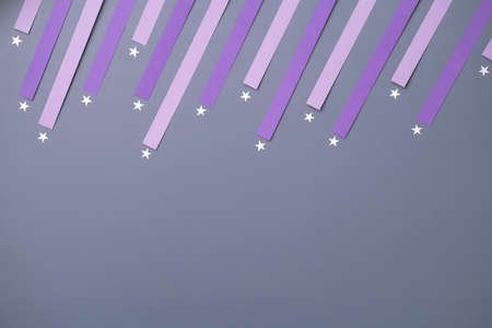 silver stars with violet paper trails on periwinkle background. Shooting star minimalist concept...