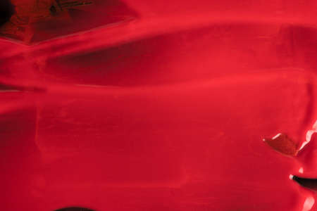 wet red paint splash on black background. Abstract vibrant background banner
