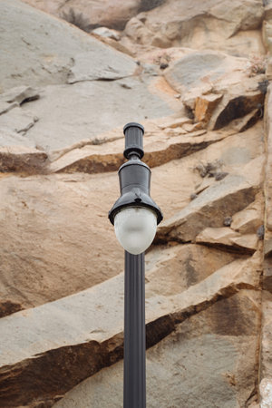Street lamp off on volcanic rock background Morro Bay California. Natural monochrome wallpaper energy and climat crisisの写真素材