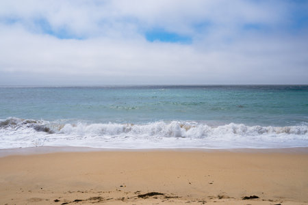 Tick Beach in California. Yellow sand white waves and blue ocean background. Traveling on highway 101 wildlife preservationの写真素材