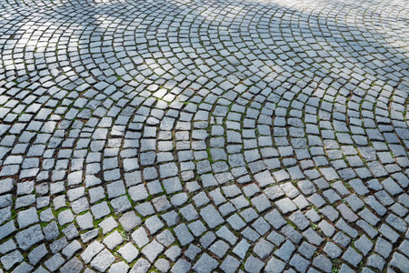Large smooth old european cobble stone pavement backgroundの写真素材