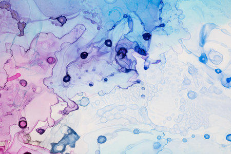 Abstract bright red pink and purple alcohol ink paint drops and splotches on white background. Art...