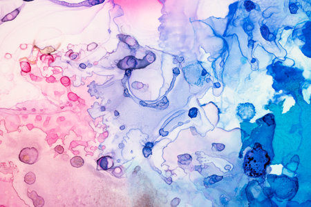 Abstract bright red pink and purple alcohol ink paint drops and splotches on white background. Art...