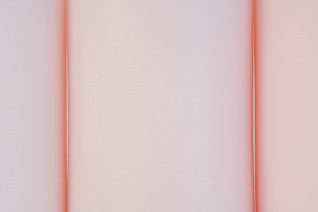 three pink round candles in a row macro photo background. Cozy home interior design