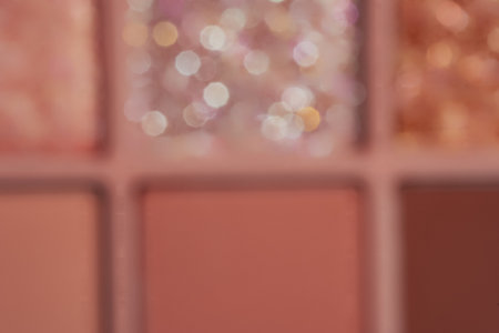 Blurred nude eyeshadow palette with glitter texture background. Cosmetic banner with beautiful bokehの写真素材