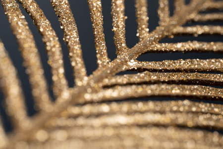 Gold glitter palm leaf on black background. Luxury vacation banner. Fancy tropical holidayの写真素材