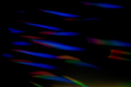 Blue and red Prism Rainbow refraction Specs on black Background Overlay. Caustics effect