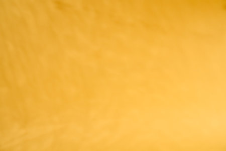 Yellow paper background with shadow texture. Sunny summer background with copyspaceの写真素材