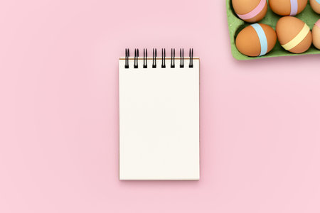 Blank spiral notebook notepad on pink background with green egg carton and decorated Easter. Flat...