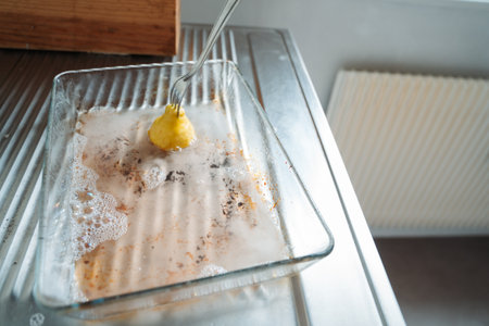Minimalist kitchen cleaning scene with lemon. Natural cleaning, household maintenance. Concept of eco-friendly cleaning methods.の写真素材