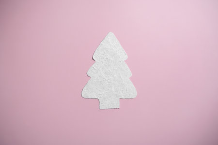 Sparkly white cream shaped like a Christmas tree on pink background. Holiday makeup and body careの写真素材