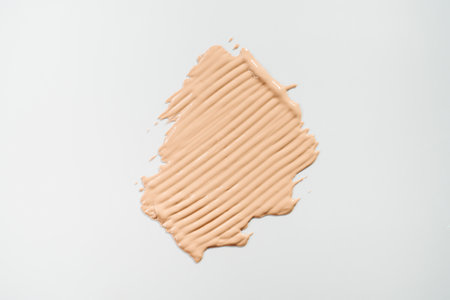 Big foundation smear on white background. Design element for cosmetic banner holiday saleの写真素材