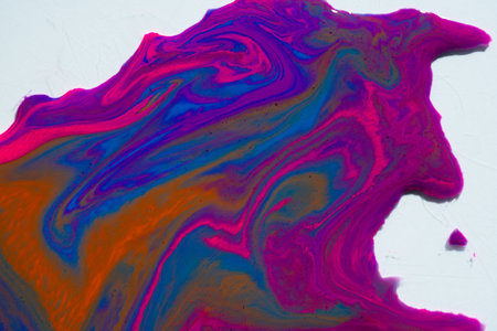 Abstract vibrant multi-color wet paint drops, swirl and splotch on white background. Purple orange and pink neon colorsの写真素材