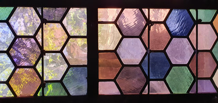 Purple and green honeycombe stained glass in medieval church. Mobile photography, real phone snapshotの写真素材