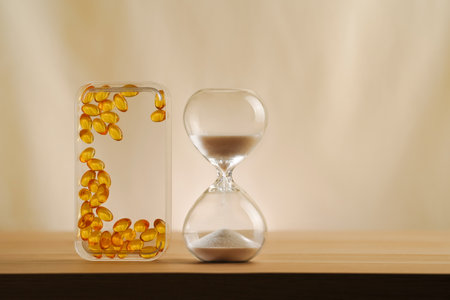 A modern still life featuring skincare vitamins with an hourglass, embodying timeless beauty and minimalism. A focus on creativity and elegance in self-care displayed on a serene, neutral backdrop.の写真素材