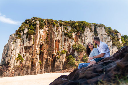 Couple in tourism on the coast of Rio Grande do Sul, Torres, RS, standing on the cliffs.の写真素材