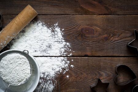 Ingredients for cooking baking on dark wooden table