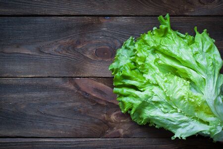 Fresh green lettuce on the dark wooden tableの写真素材