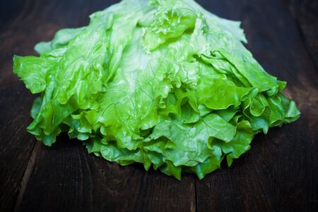 Fresh green lettuce  on the dark wooden tableの写真素材