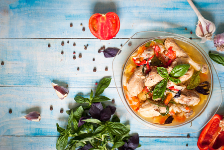 Chicken braised with vegetables and herbs - carrots, tomatoes, onions, garlic, dill, basil and pepper.の写真素材
