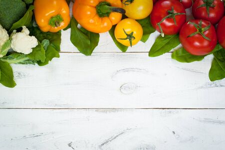 Organic food background - fresh vegetable mix at white table. Top view, Copy space.の写真素材