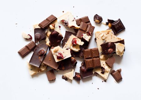Different varieties of chocolate. White chocolate with hazelnuts and cranberries, milk and dark...