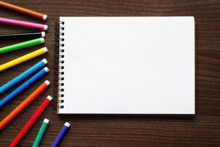 A set of markers and sketch pad at the desk. View from aboveの写真素材
