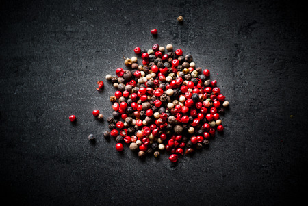 Peppercorns mixed on dark background. Top view with copy space.の写真素材