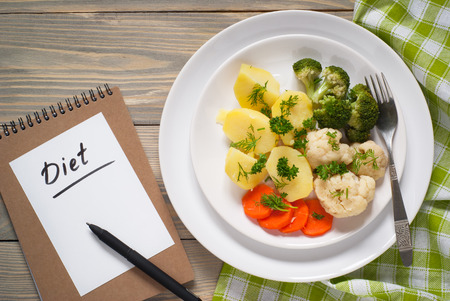 Cooking vegetables - potatoes, broccoli, cauliflower and carrots. Vegetarian lunch. Healthy food or diet concept.の写真素材