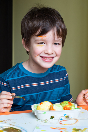 A child paints the eggs for Easter.