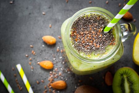 Green smoothie from fruit, leaves and seeds. A healthy eating and detox concept.の写真素材