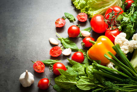 Organic fresh vegetables at slate background. Healthy eating and Diet concept.  Vegan food...