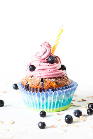 Blueberry Cupcakes decorated with whipped cream frosting and fresh blueberries on a white background. Blueberry muffins with oat flakes.の写真素材